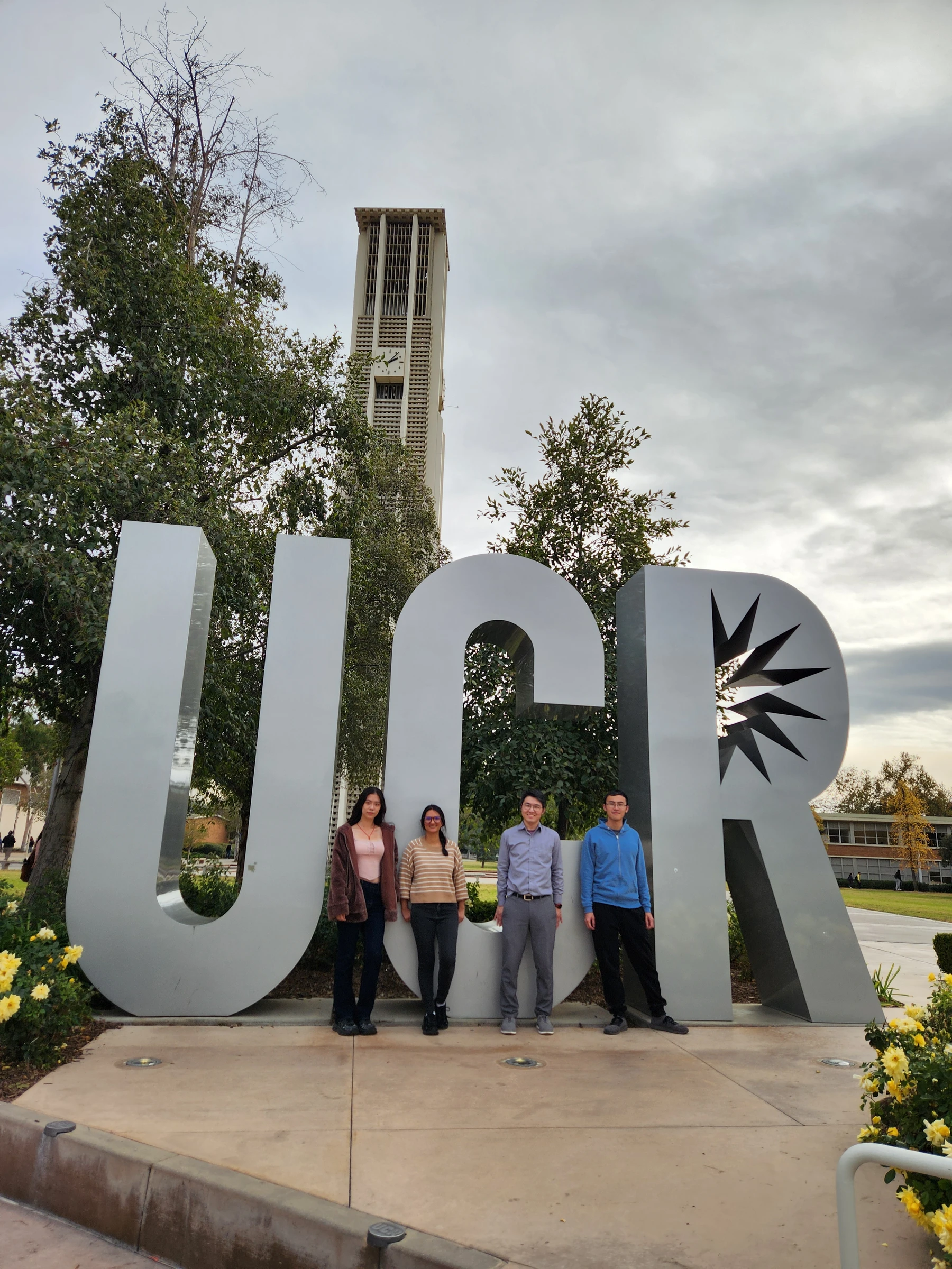 Chou Lab group photographed beside the UCR letters on campus.